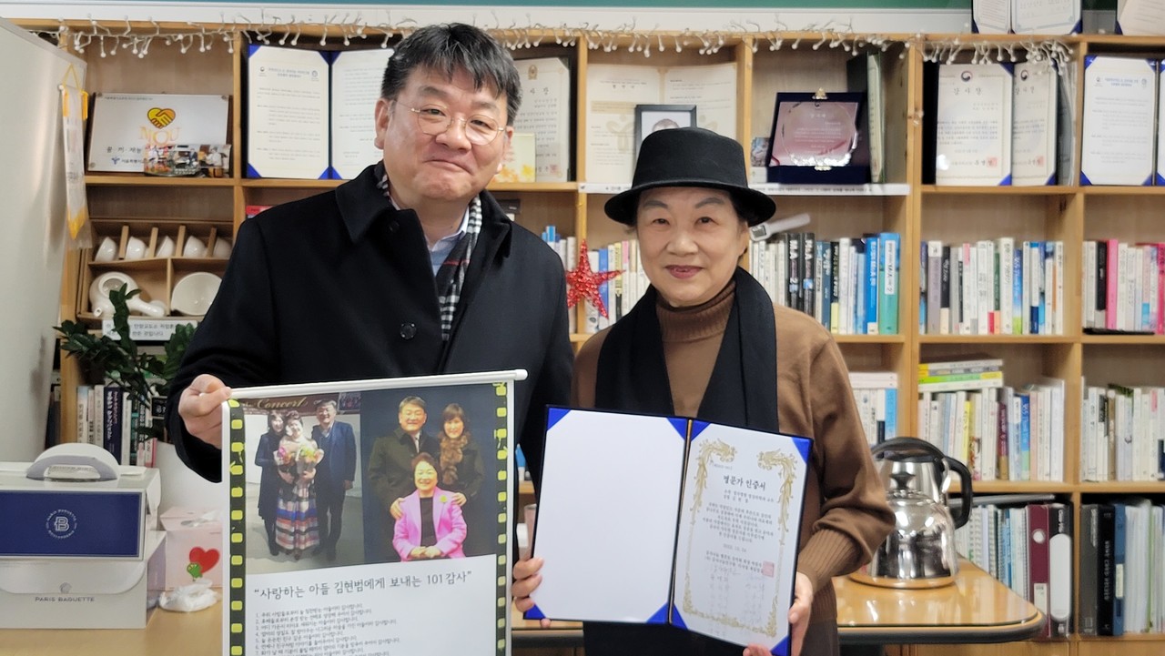 명문가인증서와 101감사 족자를 받은 임성자 회장과 아들 김현범 교수.